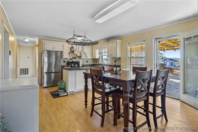 a view of a dining room with furniture window and outside view