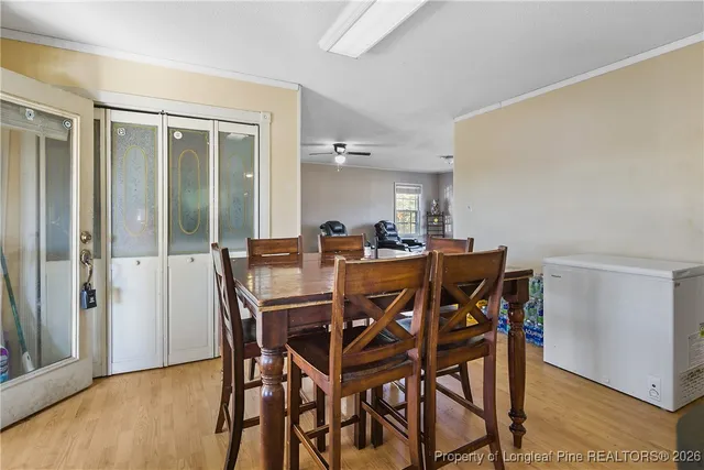 a view of a dining room with furniture and wooden floor
