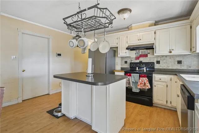 a kitchen with stainless steel appliances granite countertop a sink a stove and refrigerator
