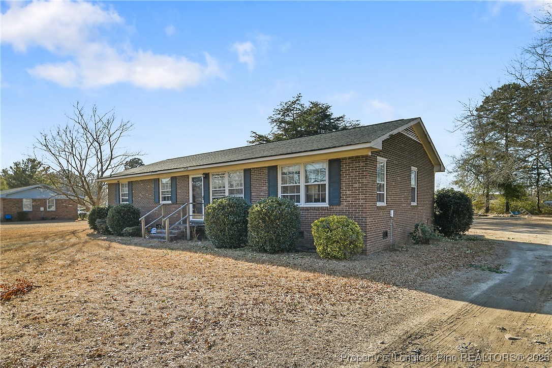1408 Seabrook School Road Fayetteville, NC 28312 - Photo 2 of 44 a front view of a house with a yard
