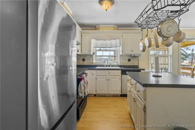 a kitchen with cabinets a sink and appliances