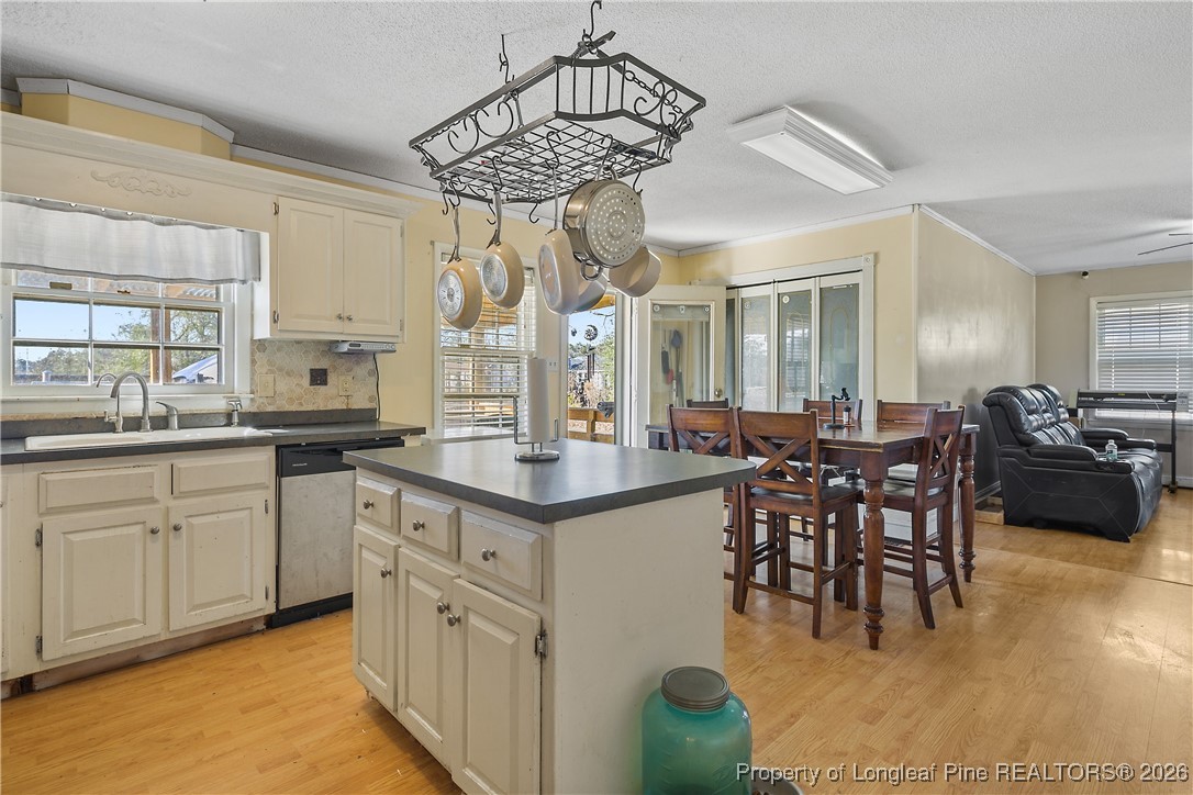 1408 Seabrook School Road Fayetteville, NC 28312 - Photo 22 of 44 a kitchen with stainless steel appliances granite countertop a sink a stove a dining table and chairs