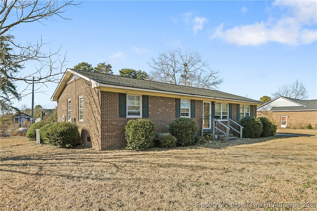 1408 Seabrook School Road Fayetteville, NC 28312 - Photo 3 of 44 a front view of a house with garden