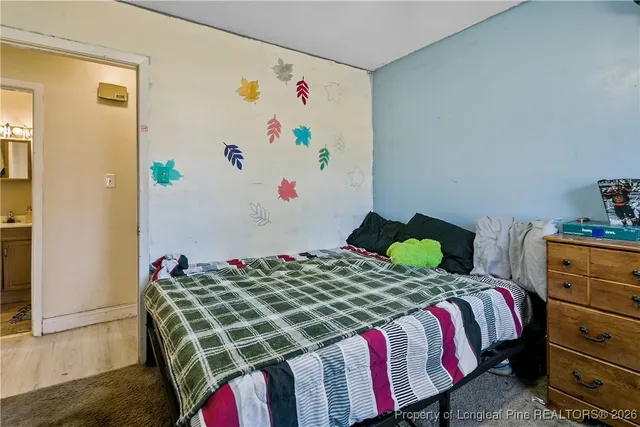 a bedroom with a bed and a dresser