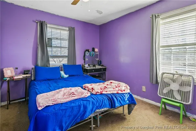 a bedroom with a bed and a chair