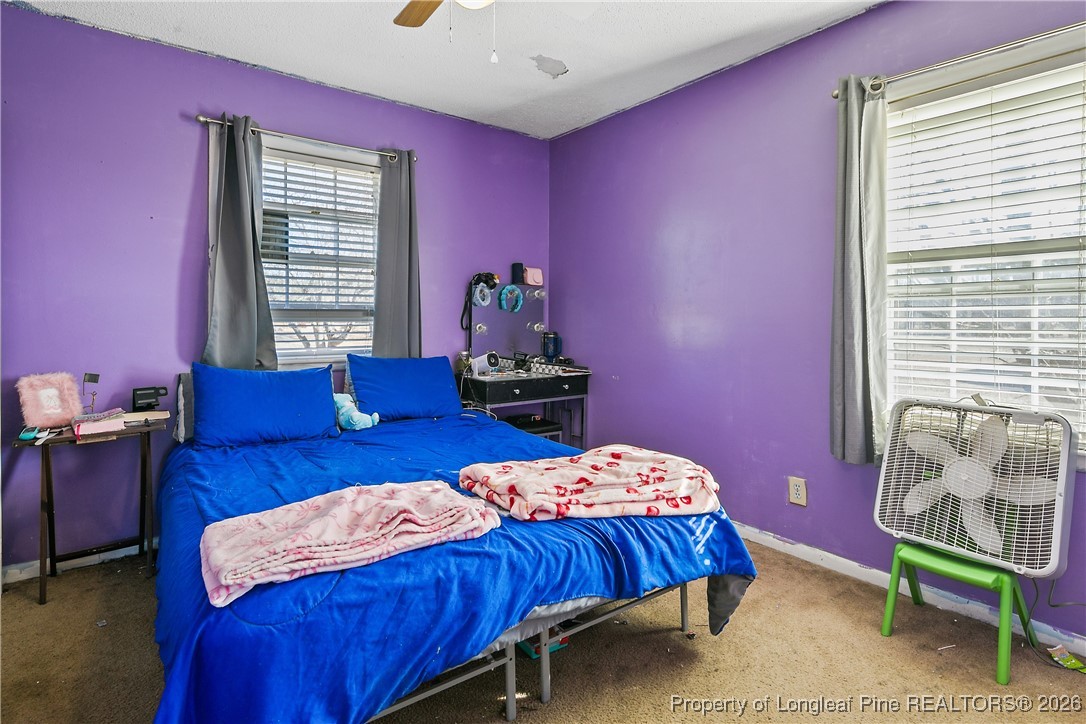 1408 Seabrook School Road Fayetteville, NC 28312 - Photo 36 of 44 a bedroom with a bed and a chair
