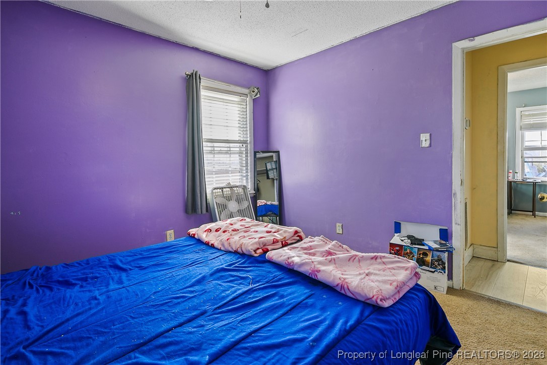 1408 Seabrook School Road Fayetteville, NC 28312 - Photo 37 of 44 a bedroom with a bed and a window