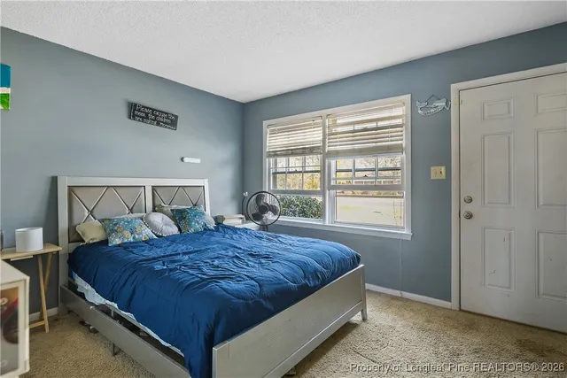 a bedroom with a bed and window