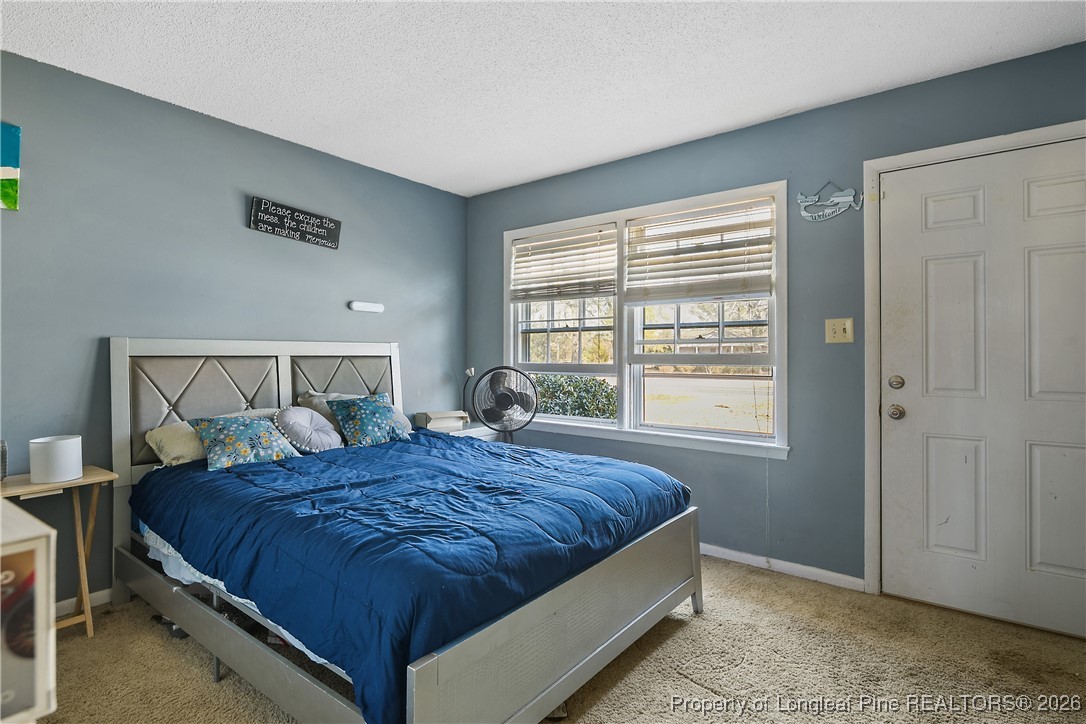 1408 Seabrook School Road Fayetteville, NC 28312 - Photo 8 of 44 a bedroom with a bed and window