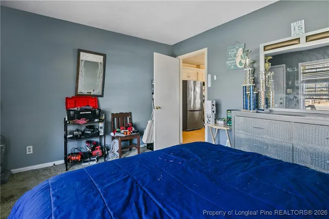 a bed room with a bed and dresser