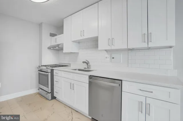 a kitchen with stainless steel appliances granite countertop a sink and dishwasher