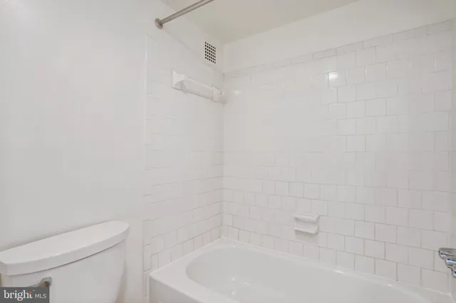 a bathroom with a bathtub and toilet