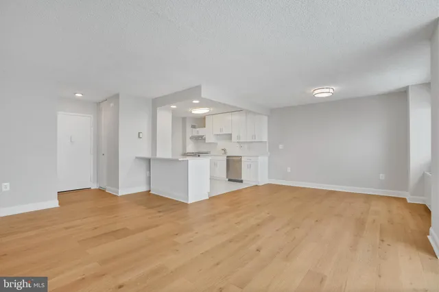 a view of kitchen with kitchen island sink and refrigerator