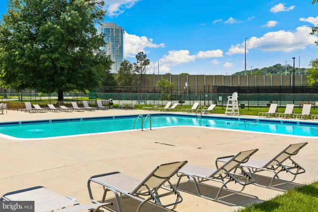 a view of swimming pool with outdoor seating and city view