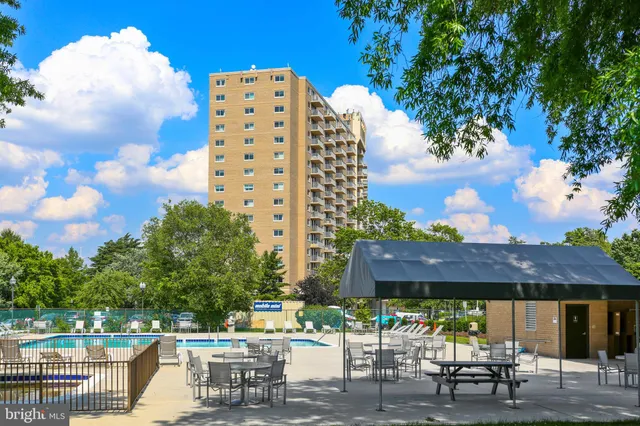 a view of a patio with a table and chairs under an umbrella