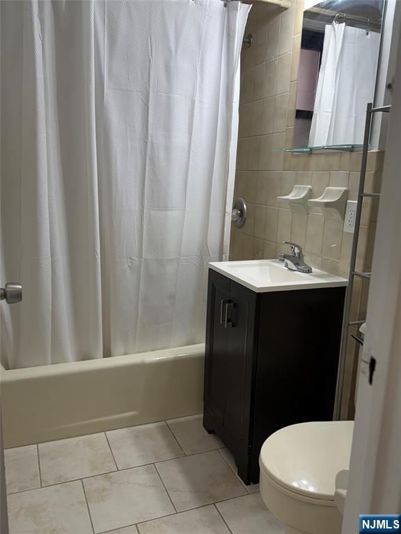 100 Prospect Avenue, Unit 2E Hackensack, NJ 07601 - Photo 12 of 16 a bathroom with a sink a toilet and shower
