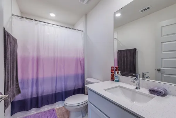 a bedroom with a bed and a mirror