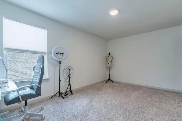 a living room with furniture and a ceiling fan