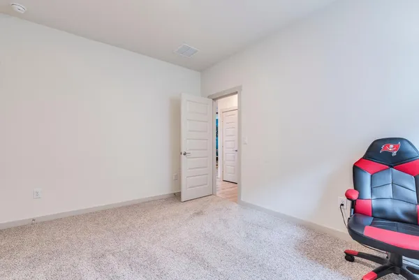 a room with gym equipment and a view of living room