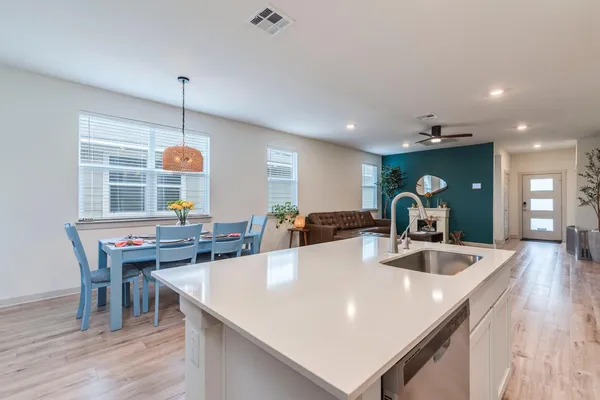 a bathroom with a sink a toilet and shower curtain