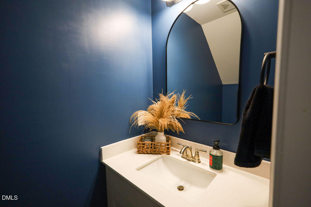 230 South Raleigh Street Angier, NC 27501 - Photo 18 of 38 a bathroom with a sink and a mirror