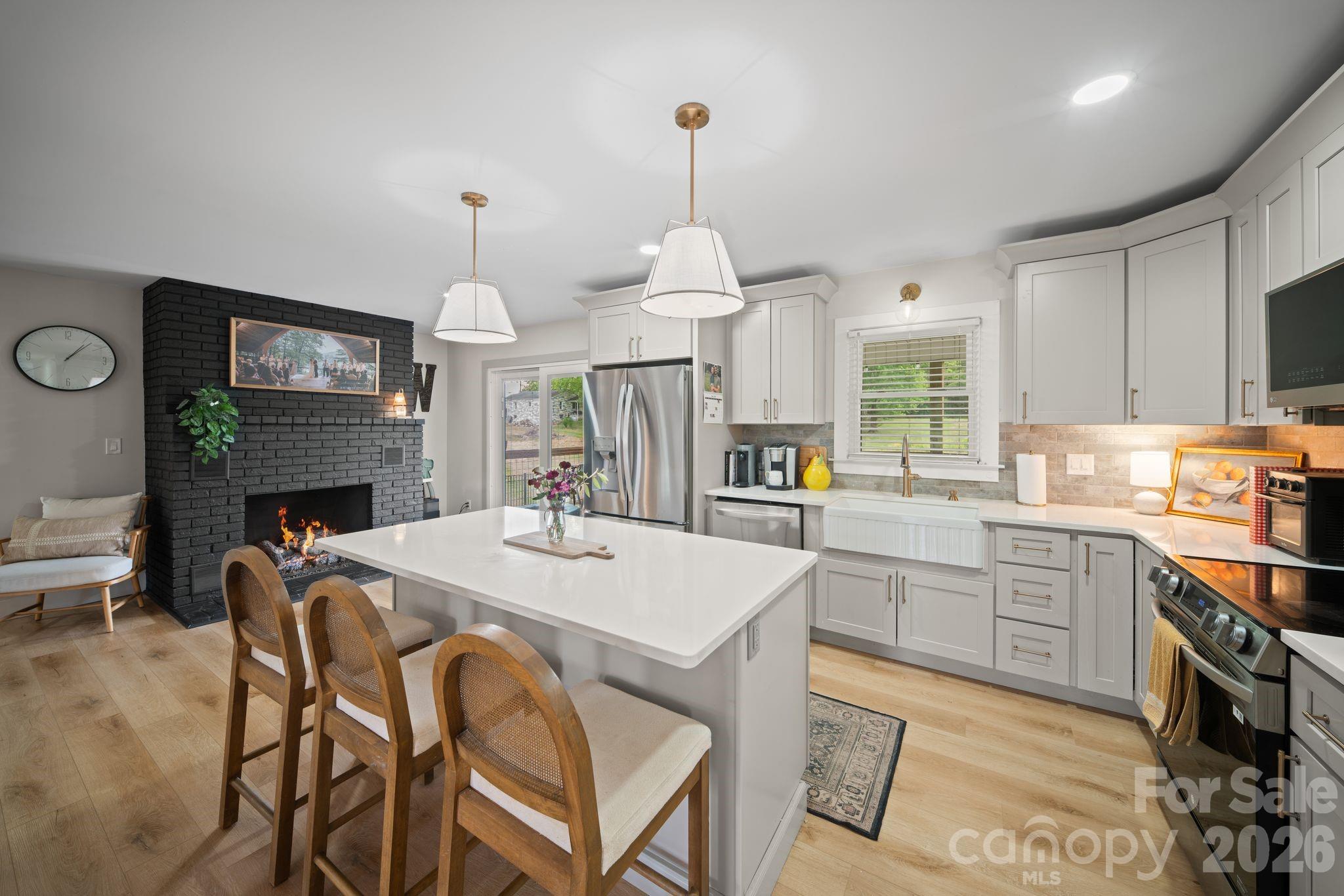 97 Paul Holland Road Canton, NC 28716 - Photo 18 of 35 a large kitchen with granite countertop a stove a sink a dining table and chairs