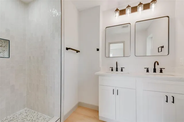 a view of empty room with wooden floor and ceiling fan