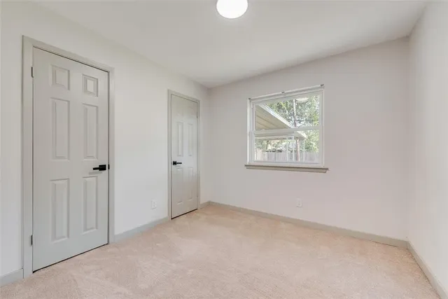 a bathroom with a toilet a sink and a window