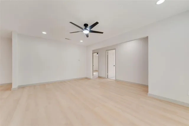 a view of an empty room with a ceiling fan