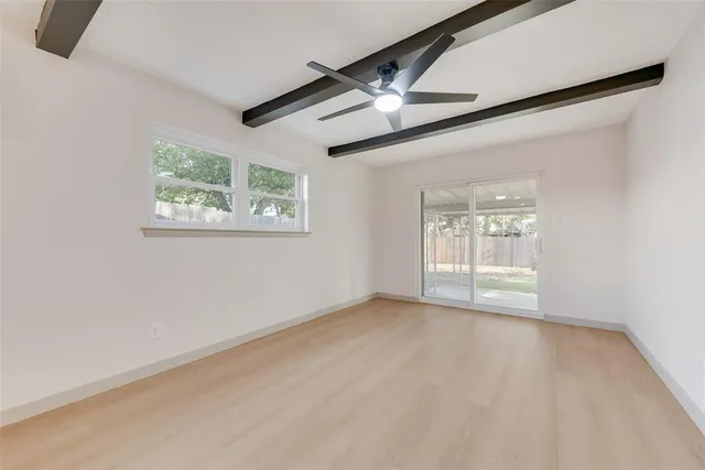a large kitchen with white cabinets and stainless steel appliances