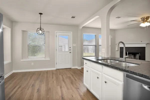 a spacious bathroom with double vanity and a mirror