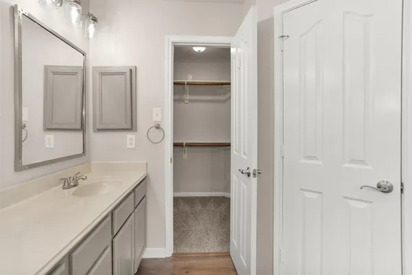 a bathroom with a double vanity sink a mirror and a shower