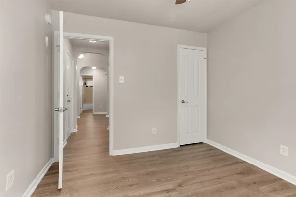 a view of a hallway with wooden floor