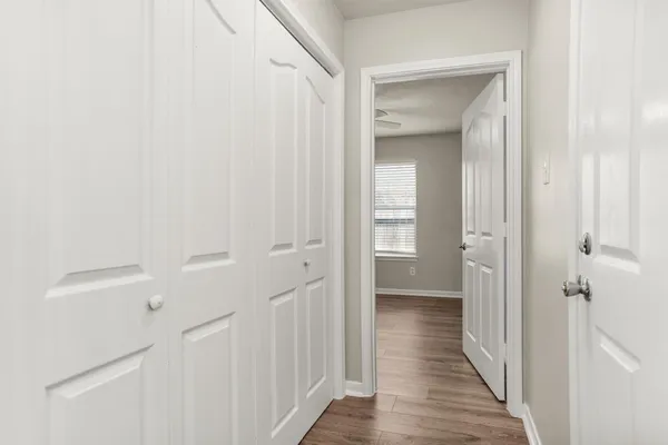 a view of a hallway with wooden floor