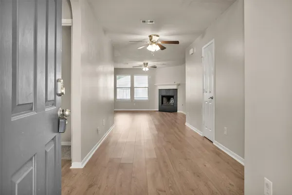 wooden floor in an empty room with a window