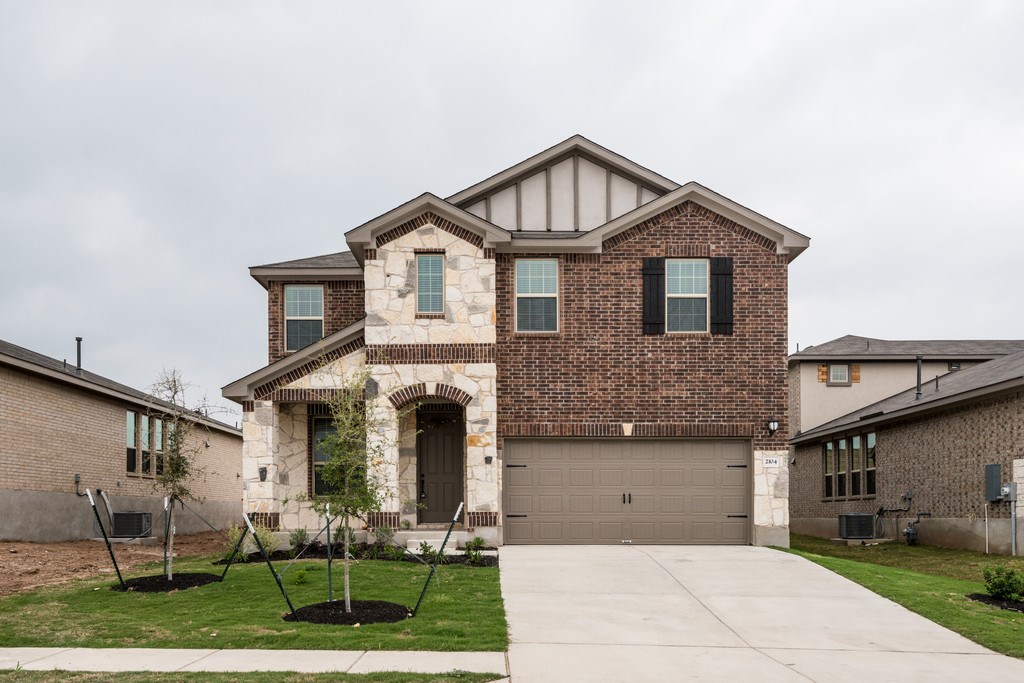 2104 Hat Bender Loop Round Rock, TX 78664 - Photo 1 of 1 a front view of a house with garden