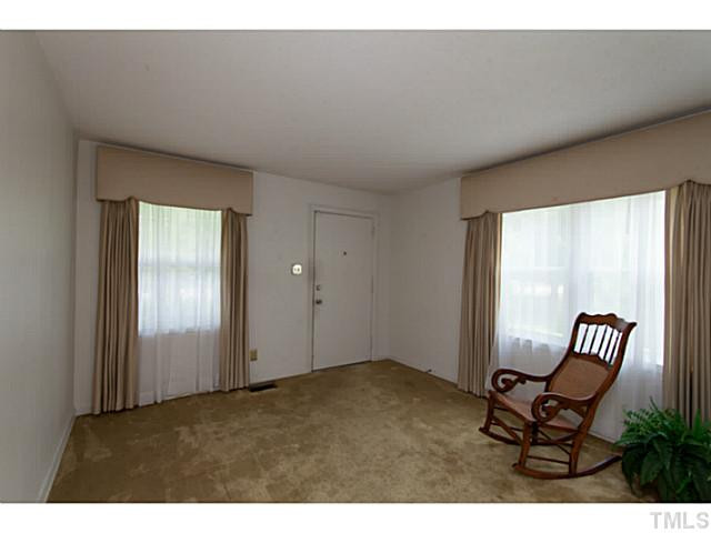 2468 Milburnie Road Raleigh, NC 27610 - Photo 5 of 25 a view of an empty room with furniture and a window
