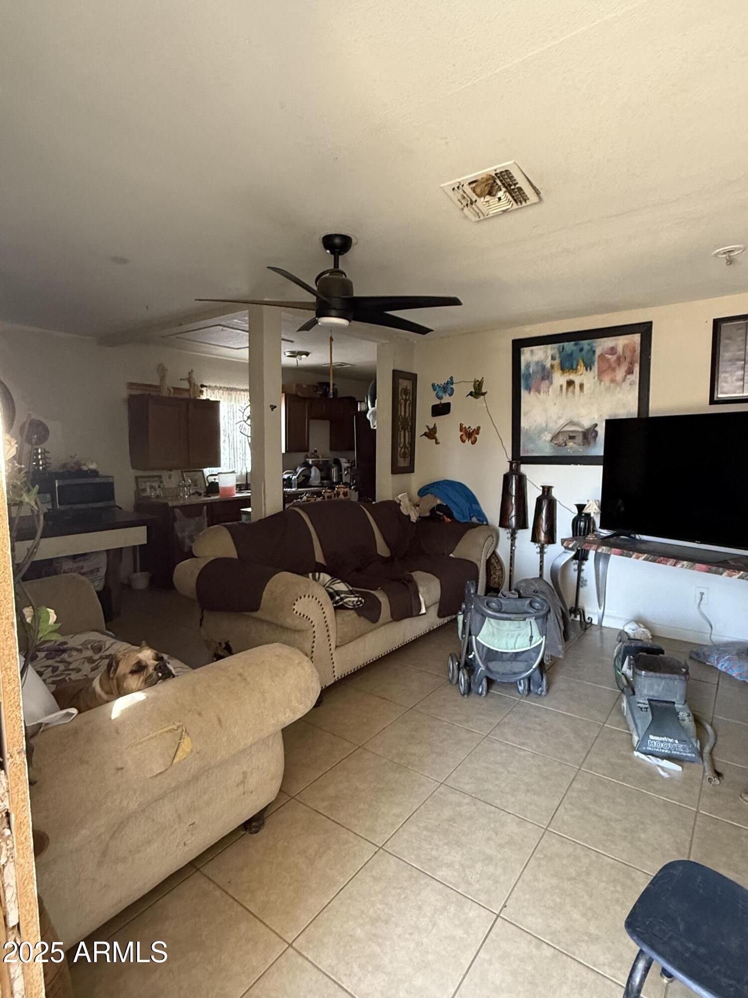 3206 West Pierce Street Phoenix, AZ 85009 - Photo 6 of 12 a living room with furniture and a flat screen tv