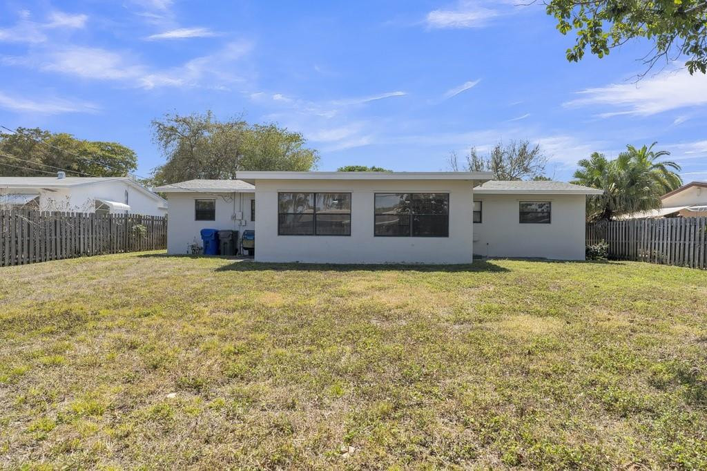 3811 Garfield Street Hollywood, FL 33021 - Photo 17 of 18 a front view of house with yard and trees in the background