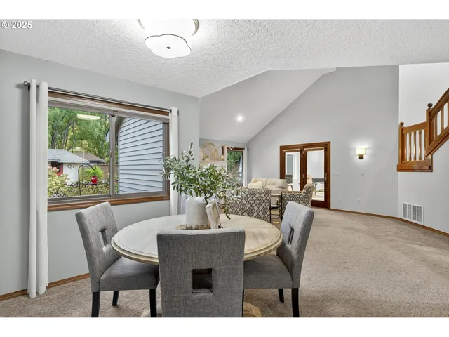 a dining room with furniture and window