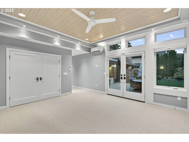 a view of empty room with wooden floor and windows