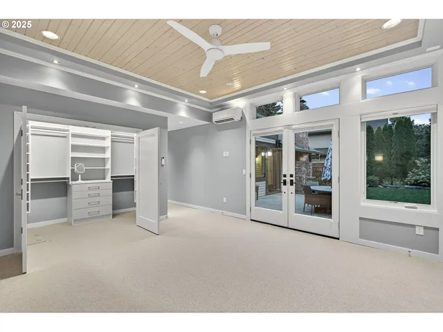 a view of an apartment with floor to ceiling windows and yard