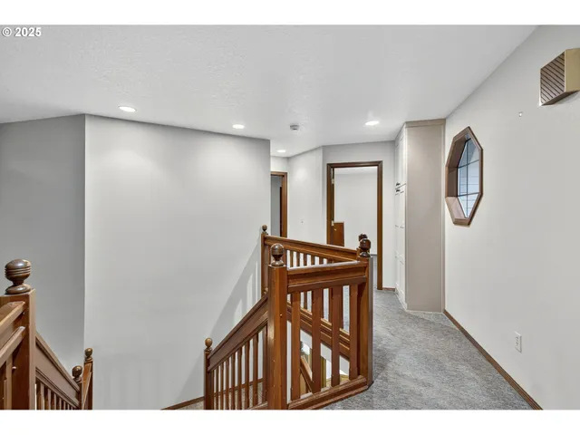 a bedroom with a bed window and a night stand in it