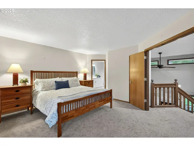 a bedroom with a bed a lamp and window