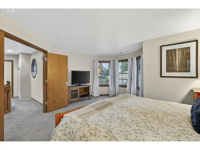 a bathroom with a toilet a sink a mirror and window