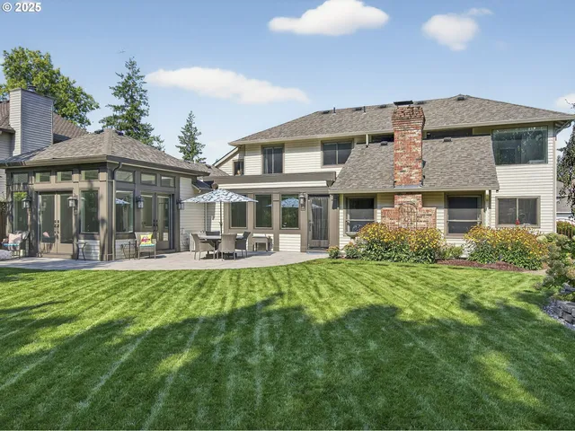 a front view of a house with swimming pool having outdoor seating