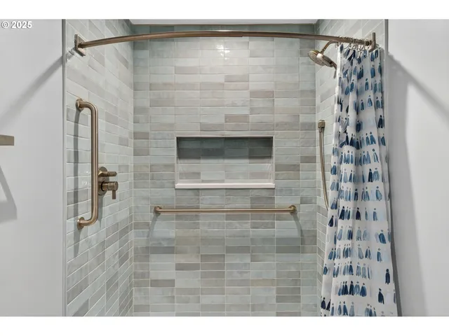 a bedroom with a bed and a painting on the wall