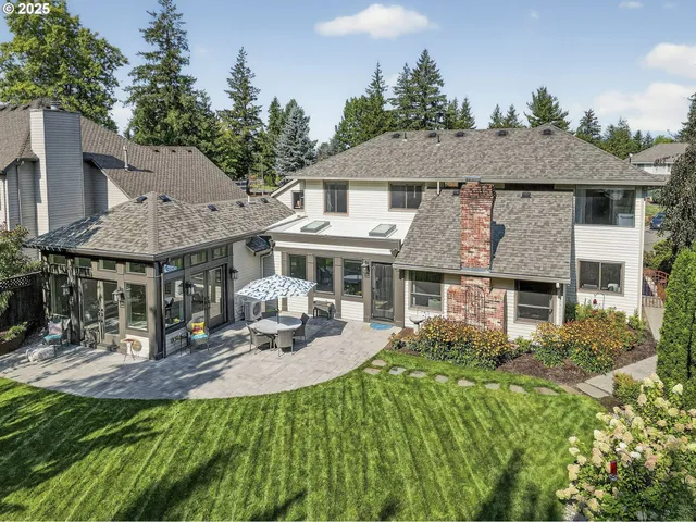 a front view of a house with a yard table and chairs