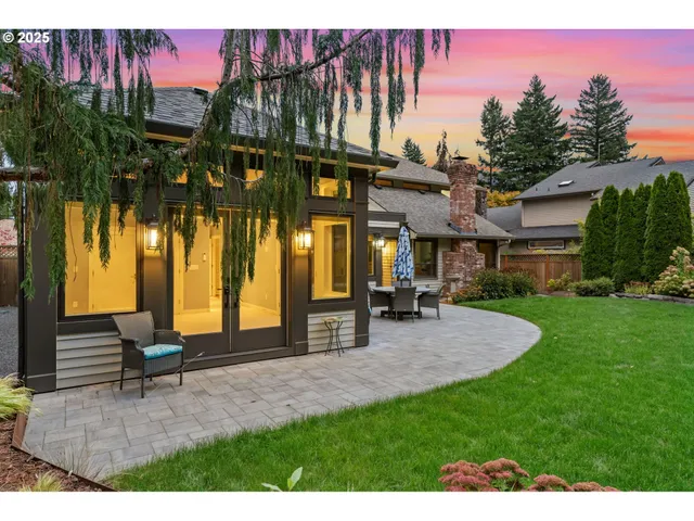 a view of a house with a yard and sitting area
