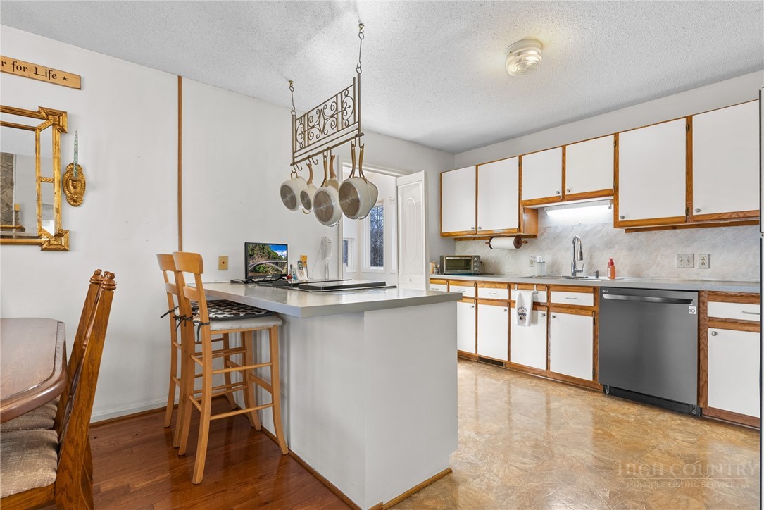 271 Quail Hollow Road Crumpler, NC 28617 - Photo 12 of 30 a kitchen with stainless steel appliances granite countertop white cabinets a sink and a stove